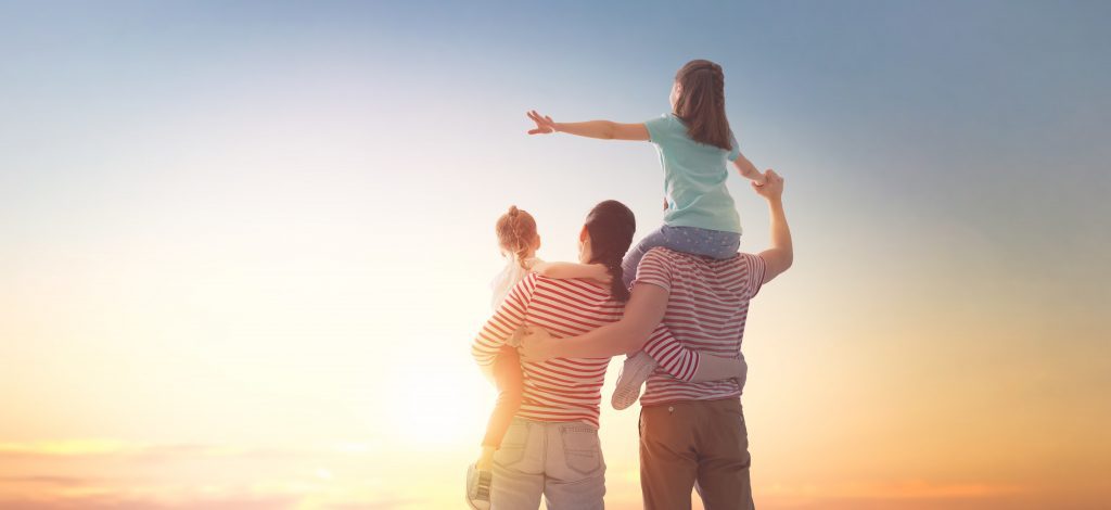 happy family at sunset celebrating financial planning success dreaming about future